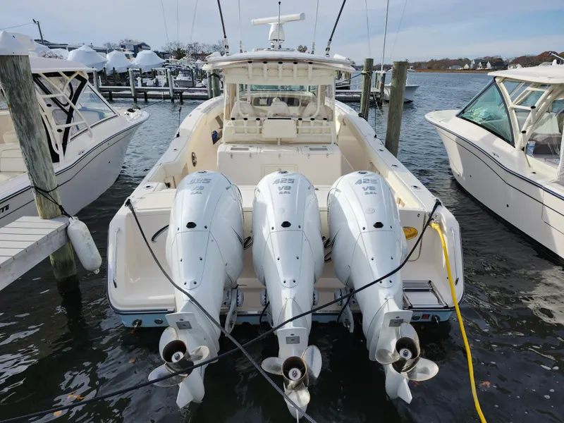 Slide: The Image of 2023 Grady-White Canyon 376 boat docked with triple outboard engines. - 14