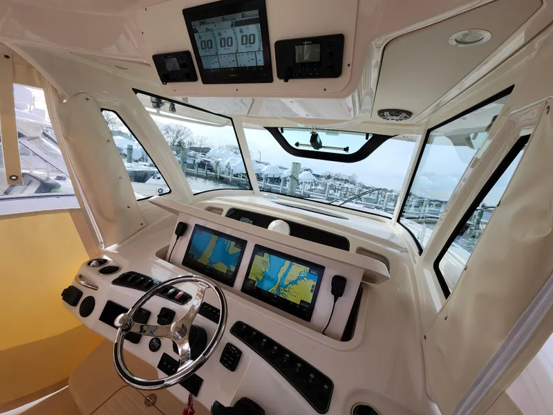 Slide: The Image of 2023 Grady-White Canyon 376 helm with dual navigation screens and steering wheel. - 17