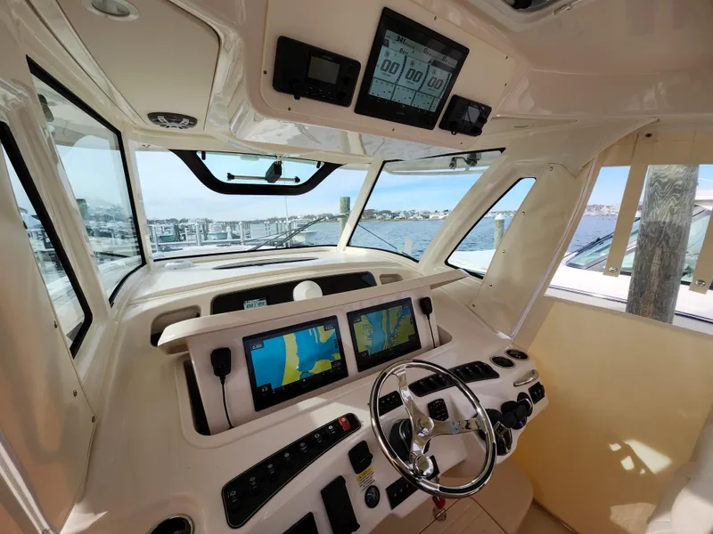 Slide: The Image of 2023 Grady-White Canyon 376 boat dashboard with dual navigation screens. - 18