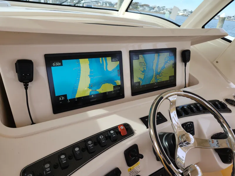 Slide: The Image of 2023 Grady-White Canyon 376 boat dashboard with Garmin navigation display. - 19