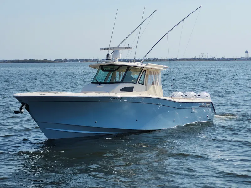 Slide: The Image of 2023 Grady-White Canyon 376 boat cruising on open water. - 2