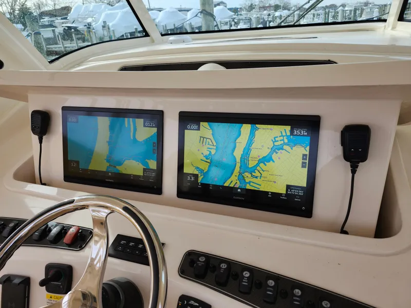 Slide: The Image of 2023 Grady-White Canyon 376 boat dashboard with digital displays and controls. - 20