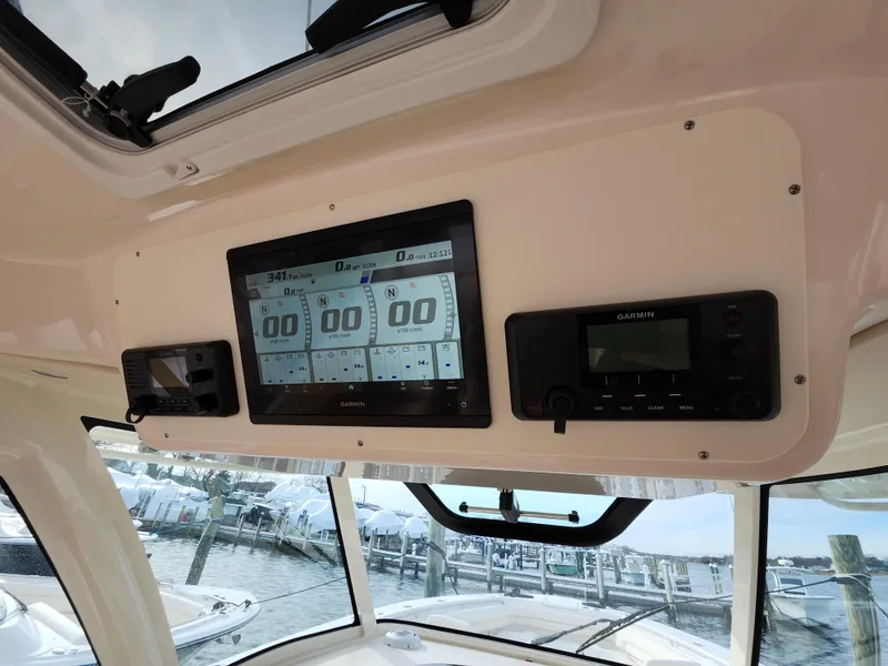 Slide: The Image of 2023 Grady-White Canyon 376 boat interior with three beige captain's chairs. - 22