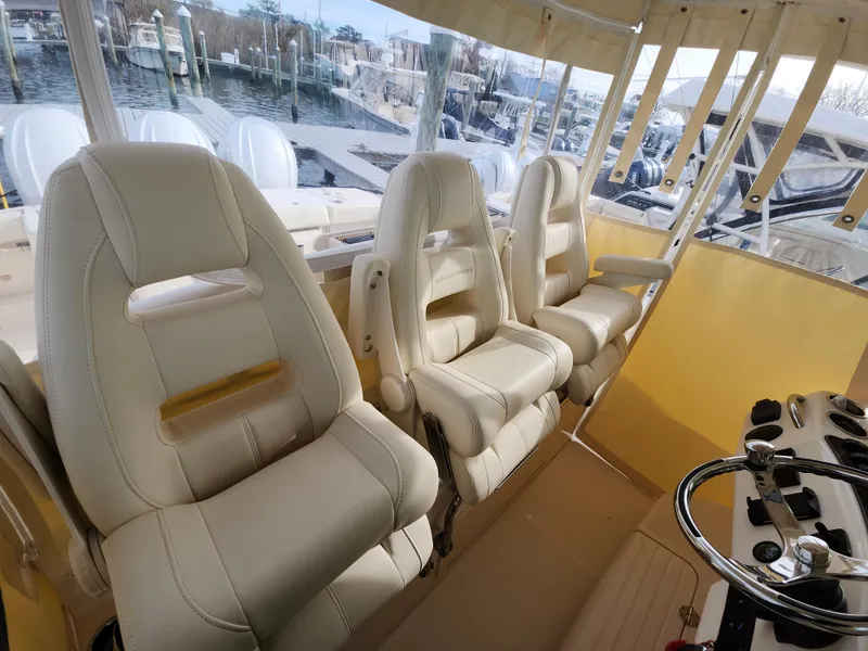 Slide: The Image of Control panel of 2023 Grady-White Canyon 376 boat with throttle and switches. - 23