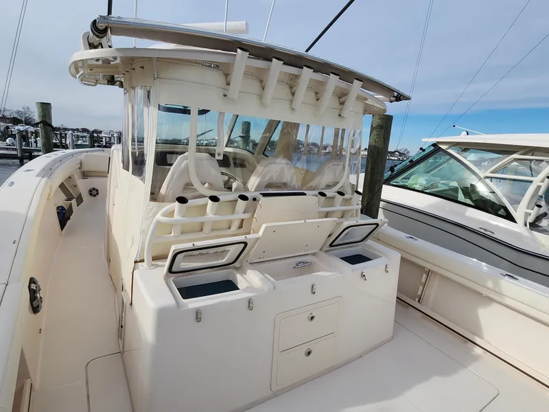 Slide: The Image of 2023 Grady-White Canyon 376 boat interior with triple engines at a marina. - 27