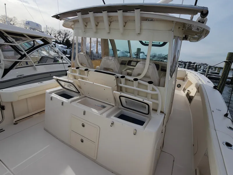 Slide: The Image of 2023 Grady-White Canyon 376 boat docked, showcasing spacious deck and powerful engines. - 28