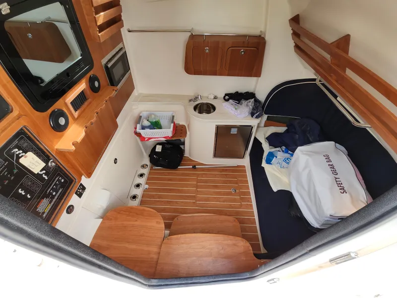 Slide: The Image of 2023 Grady-White Canyon 376 boat interior with toilet and control panel. - 37