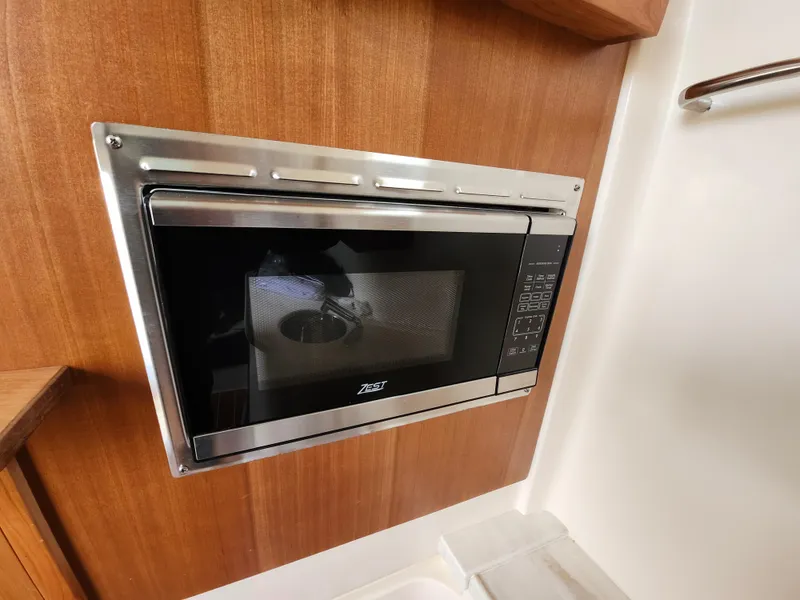 Slide: The Image of 2023 Grady-White Canyon 376 boat storage compartment with rod holders. - 46