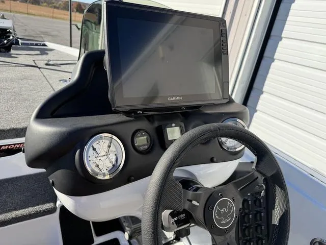 Slide: The Image of 2025 Phoenix 721 ZXL boat dashboard with Garmin display and steering wheel. - 19