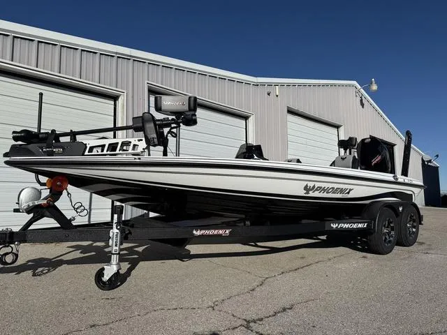 Slide: The Image of 2025 Phoenix 721 ZXL boat on trailer, parked near metal building. - 6