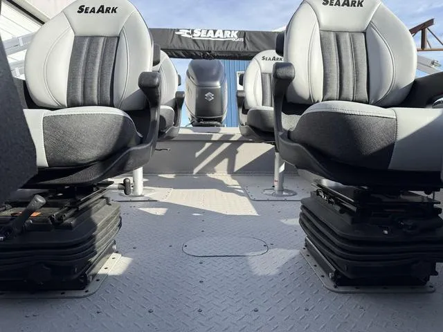 Slide: The Image of 2025 SeaArk Pro Cat 240 boat interior with cushioned seats and Suzuki engine. - 12