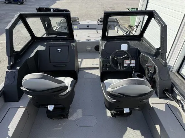 Slide: The Image of 2025 SeaArk Pro Cat 240 boat interior with dual seats and steering console. - 13