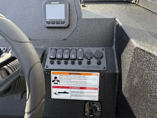 Slide: The Image of Dashboard of 2025 SeaArk Pro Cat 240 boat with controls and Suzuki display. - 16