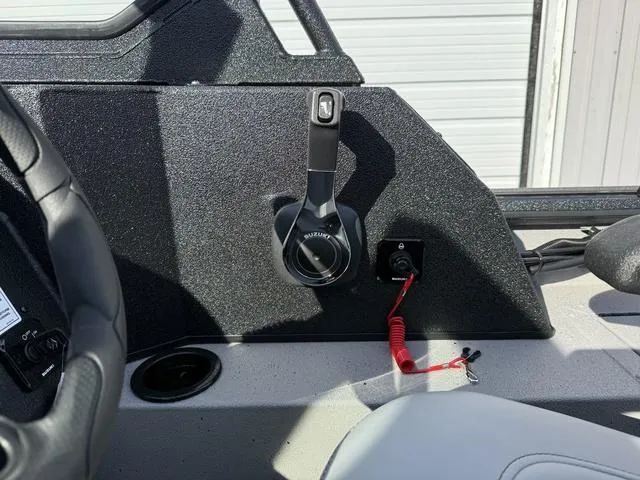 Slide: The Image of 2025 SeaArk Pro Cat 240 boat control panel with throttle lever and safety lanyard. - 17