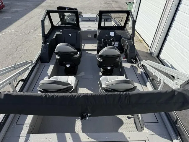 Slide: The Image of 2025 SeaArk Pro Cat 240 boat interior with seating and steering console. - 20