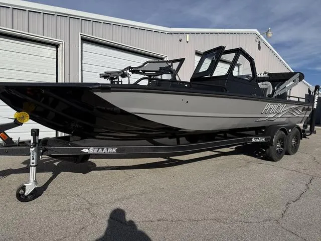 Slide: The Image of 2025 SeaArk Pro Cat 240 boat on trailer, parked outside a garage. - 4