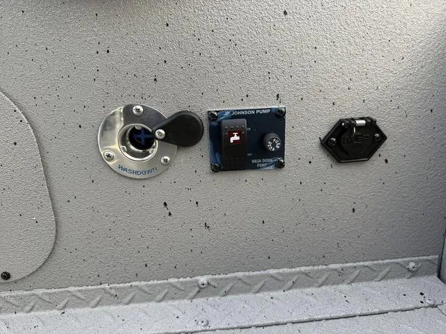 Slide: The Image of Close-up of 2025 SeaArk Pro Cat 240 boat washdown and pump controls. - 8