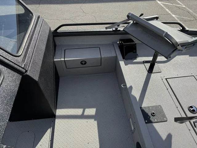 Slide: The Image of 2025 SeaArk Pro Cat 240 boat interior with storage compartments and seating area. - 9