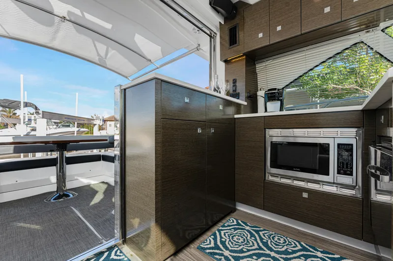 Slide: The Image of Interior of 2018 Cruisers Yachts 50 Cantius, featuring modern kitchen and dining area. - 44