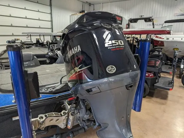 Slide: The Image of 2018 Skeeter FX20 with Yamaha 250 outboard motor in a garage setting. - 8