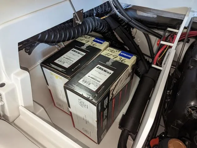 Slide: The Image of 2023 Crownline 240 SS engine compartment with two Deka marine batteries. - 11
