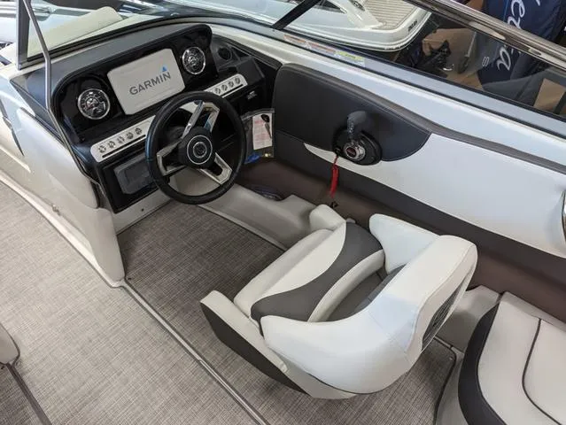 Slide: The Image of Interior of 2023 Crownline 240 SS boat with Garmin navigation system and modern steering wheel. - 12