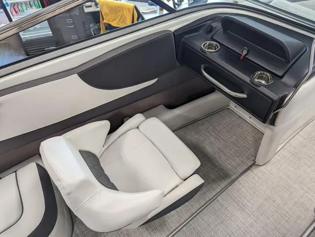 Slide: The Image of 2023 Crownline 240 SS boat interior with white seating and cup holders. - 13