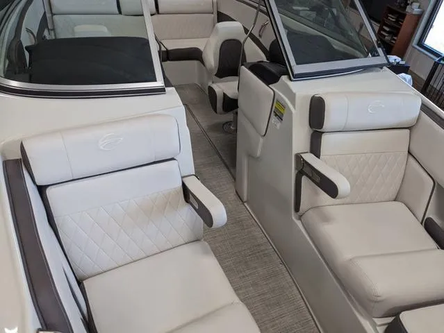 Slide: The Image of 2023 Crownline 240 SS boat interior with luxurious white seating and modern design. - 15
