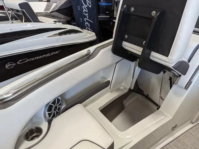 Slide: The Image of 2023 Crownline 240 SS boat interior with white seating and speaker detail. - 16