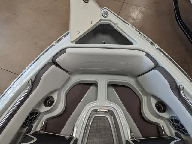 Slide: The Image of 2023 Crownline 240 SS boat interior with cushioned seating and storage compartments. - 18