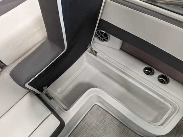 Slide: The Image of 2023 Crownline 240 SS boat interior with storage compartment and speaker. - 20