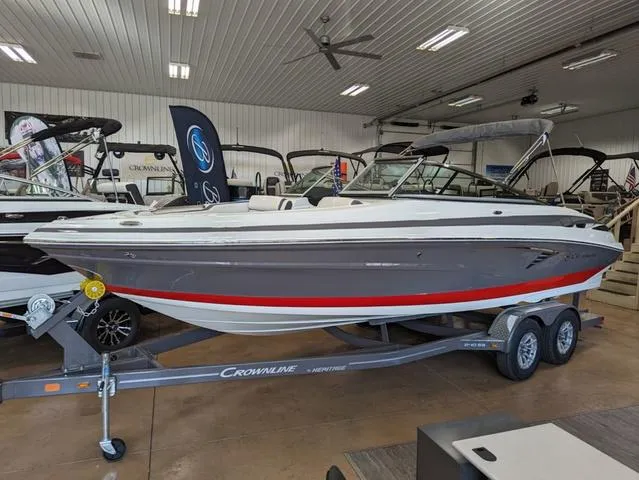 Slide: The Image of 2023 Crownline 240 SS boat on trailer in showroom. - 22