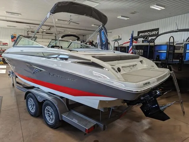 Slide: The Image of 2023 Crownline 240 SS boat on trailer in showroom. - 4