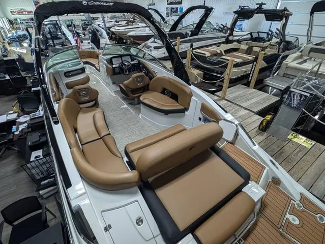 Slide: The Image of 2024 Crownline 290 SS boat interior with luxurious seating and modern design in showroom. - 3