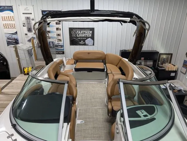 Slide: The Image of 2024 Crownline 290 SS boat interior with tan leather seating and sleek design. - 5