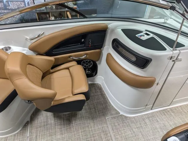 Slide: The Image of 2024 Crownline 290 SS boat interior with tan leather seating and modern dashboard. - 8