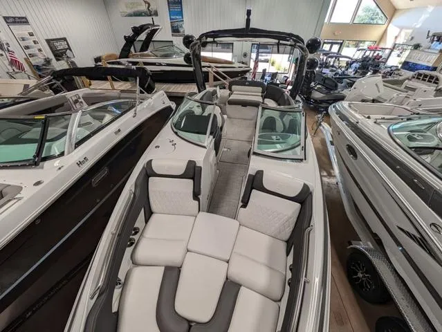 Slide: The Image of 2024 Crownline 280 SS boat interior in showroom, featuring spacious seating and modern design. - 11