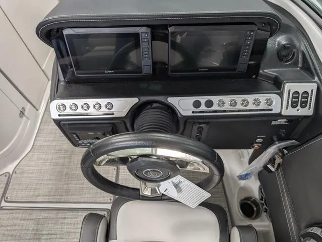 Slide: The Image of 2024 Crownline 280 SS boat dashboard with dual Garmin displays and modern controls. - 15