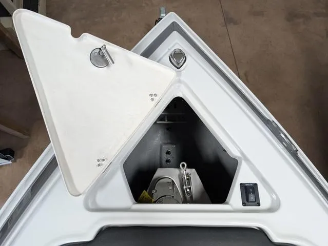 Slide: The Image of 2024 Crownline 280 SS boat anchor compartment with open hatch. - 20