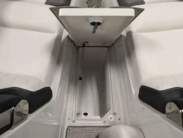 Slide: The Image of 2024 Crownline 280 SS boat interior with white seating and storage compartment. - 22