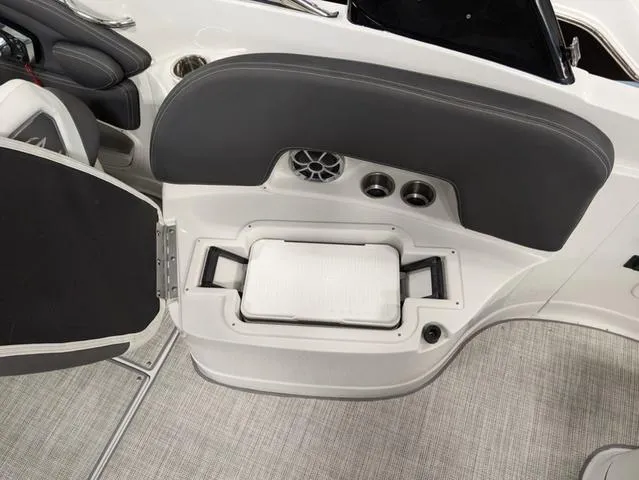 Slide: The Image of 2024 Crownline 280 SS boat interior with storage compartment and cup holders. - 24