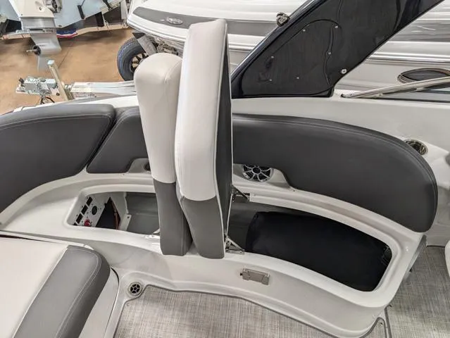 Slide: The Image of 2024 Crownline 280 SS boat interior with open storage compartments and seating. - 25