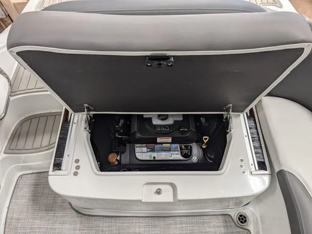 Slide: The Image of 2024 Crownline 280 SS boat engine compartment with open hatch. - 26