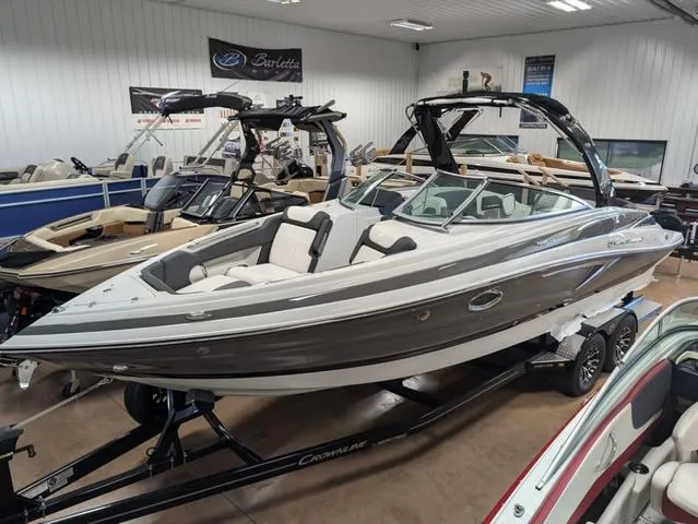 Slide: The Image of 2024 Crownline 280 SS boat in showroom, sleek design, gray and white exterior. - 5