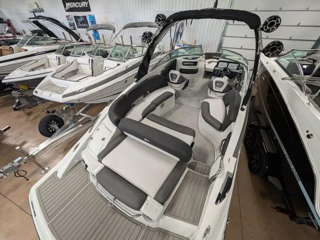 Slide: The Image of 2024 Crownline 280 SS boat interior with sleek seating and modern design in showroom. - 9