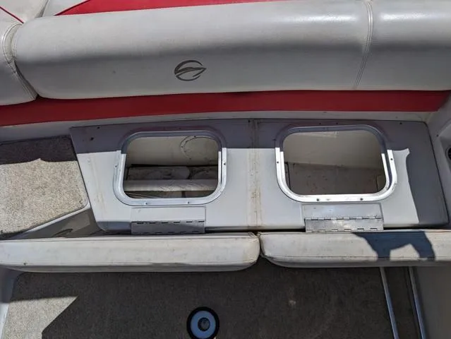 Slide: The Image of Interior of a 2006 Crownline 220 LS boat showing storage compartments. - 12