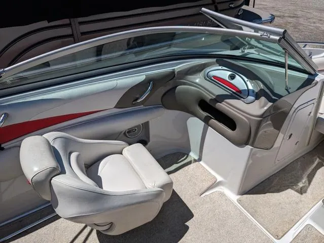 Slide: The Image of 2006 Crownline 220 LS boat interior with gray seating and sleek dashboard design. - 13