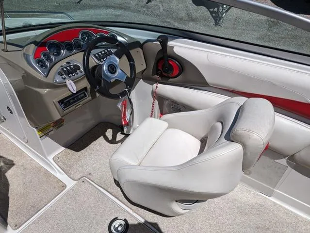 Slide: The Image of 2006 Crownline 220 LS boat interior with steering wheel and white seating. - 14