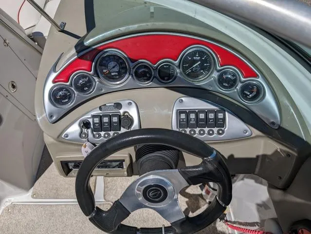 Slide: The Image of Dashboard of a 2006 Crownline 220 LS boat with gauges and steering wheel. - 15