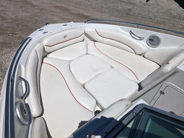 Slide: The Image of 2006 Crownline 220 LS boat interior with white cushioned seating and red accents. - 16